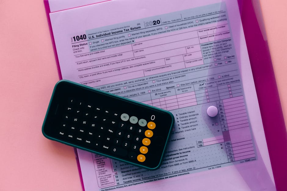 Tax form 1040 with a calculator on a pink background, highlighting finance and accounting themes.